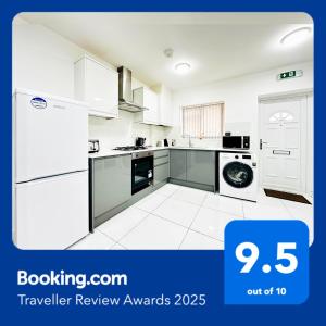 a white kitchen with a refrigerator and a dishwasher at Apartment in East Ham, London in London