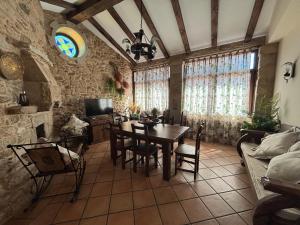 a dining room with a table and chairs in a room at Casa Labrega da Torre in Silleda