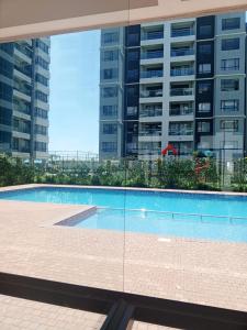 a swimming pool in front of a tall building at Polar homes in Nairobi