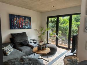 a living room with a couch and a table at EifelQuartier L2 in Schleiden