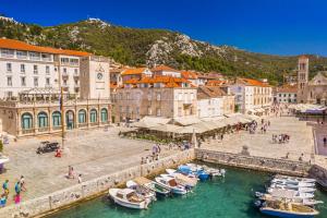 a group of boats in the water in a city at Lina Vranković Apartments in Hvar