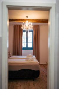 Postel nebo postele na pokoji v ubytování Mikulov Apartmány MAGISTR