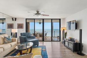 a living room with a couch and a table at Beach Club Siesta #104 in Key West