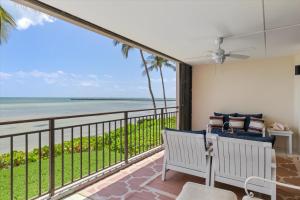 a room with a balcony with a view of the ocean at Beach Club Siesta #104 in Key West