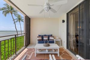 a balcony with a bed and a view of the ocean at Beach Club Siesta #104 in Key West +32 photos