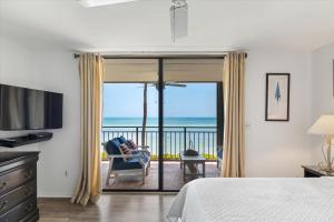 a bedroom with a bed and a view of the ocean at Beach Club Siesta 104 in Key West