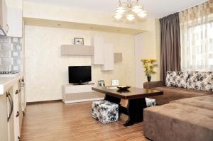 a living room with a couch and a table at Apartment Ovidius - by the beach in Constanţa