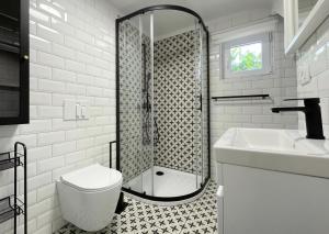 a bathroom with a shower and a toilet and a sink at Vista Mare in Kaštel