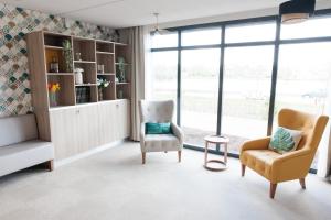 a living room with two chairs and a couch at Résidence Marignan in Elbeuf
