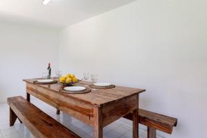 a wooden table with a bowl of fruit on it at Portugal Active Bandeira Retreat in Viana do Castelo