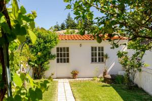 a white house with a garden in front of it at Portugal Active Bandeira Retreat in Viana do Castelo