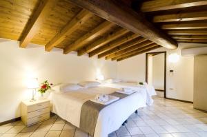 a bedroom with two beds in a room with wooden ceilings at Agriturismo La Torretta da Valentina in Solferino