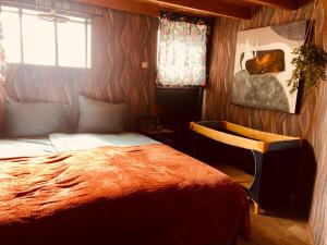 a bedroom with a large bed and a window at Retraitre bij de brug in Zuidveld
