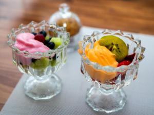 two glass bowls filled with fruit on a table at Sage Haven Guesthouse in Modimolle