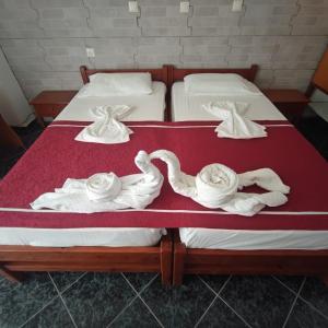 two beds with swans made out of towels on them at Kefalos Luxury Apartments in Kefalos +25 photos