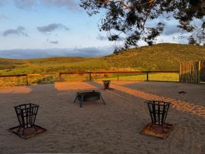 a patio with a picnic table and two chairs at Wetlands Game Lodge in Wakkerstroom