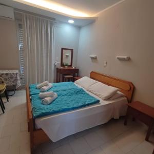 a bedroom with a bed with two towels on it at Kefalos Luxury Apartments in Kefalos