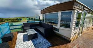 a tiny house with a pool on a deck at Caravan Nr 51 Only for Family Holiday in Longmanhill