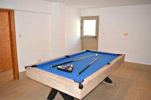 a pool table with four balls on top of it at Villa Anastasia Sandy Beach Villas - Heated Private Overflow Pool - Hot Tub - Games Room - Private Beach Area in Polis Chrysochous +73 photos