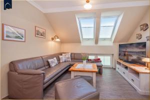 a living room with a couch and a table at Koserow Hauptstraße 102 Whg 4 in Ostseebad Koserow