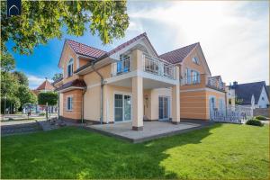 a large house with a lawn in front of it at Koserow Hauptstraße 102 Whg 4 in Ostseebad Koserow