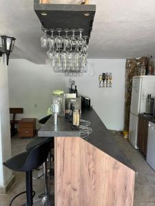 a kitchen with a counter with chairs and a counter top at The Byala Escape, Private Villa with Bar & Hot Tub in Byala
