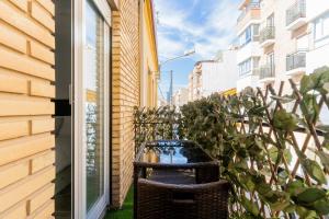 a balcony with a bench next to a building at Enjoy Valencia: Deluxe Apartment with Terrace in Valencia
