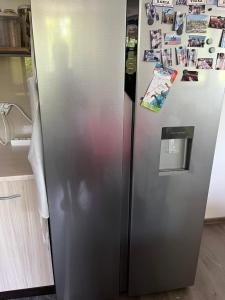 a stainless steel refrigerator in a kitchen at The Byala Escape, Private Villa with Bar & Hot Tub in Byala