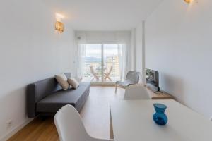 a living room with a couch and a table at Canet Seaview Gem: Pool & Beach Proximity in Canet de Berenguer