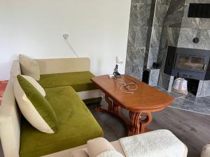 a living room with a couch and a fireplace at The Byala Escape, Private Villa with Bar & Hot Tub in Byala