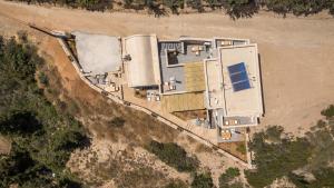 an aerial view of a house on the beach at Comodo Studios in Kythira