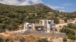 a house on the side of a mountain at Comodo Studios in Kythira
