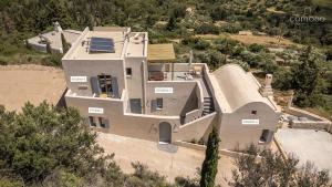an aerial view of a large house with a slope at Comodo Studios in Kythira