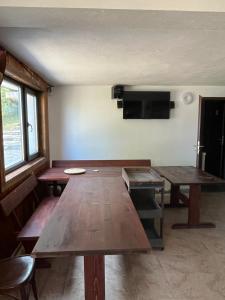 a room with a table and a flat screen tv at The Byala Escape, Private Villa with Bar & Hot Tub in Byala