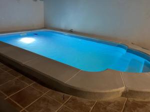 a swimming pool with blue water in a room at Villa`s Safara in Safara