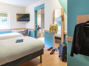 Postel nebo postele na pokoji v ubytování ibis budget Basel Pratteln