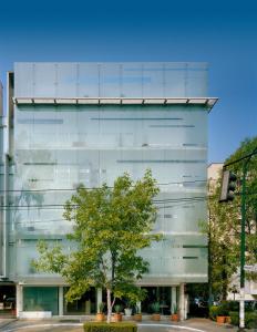 a glass building with a tree in front of it at Habita, Mexico City, a Member of Design Hotels in Mexico City