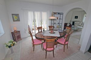 a dining room with a table and chairs at Casa Rododendro by HolAp SA in Ascona