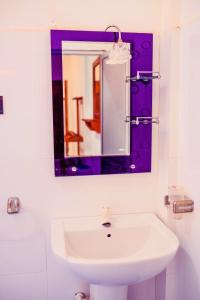 a bathroom with a sink and a mirror at Hilton Cottage in Trincomalee +75 photos