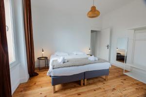 a bedroom with a bed and a large window at Maison Yasmyn in Villeurbanne +19 photos