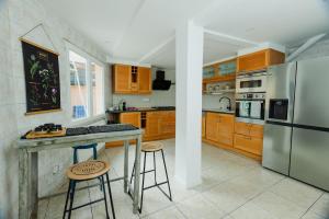 a kitchen with wooden cabinets and stainless steel appliances at Maison Yasmyn in Villeurbanne
