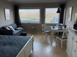 a bedroom with a bed and a table and a couch at Seeblick in Fehmarn