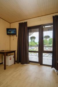 an empty room with a sliding glass door with a balcony at Villa MARINA in Solotvyno