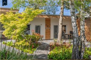 a home with a patio and trees in the yard at Green Village Igelnest in Benz
