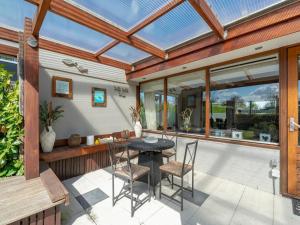 a patio with a black table and chairs at Holiday Home Sint Maartenszee near Beach in Sint Maartensvlotbrug