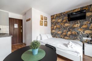 a living room with a couch and a table at RentPlanet - Studio Rynek Ratusz in Wrocław +6 photos