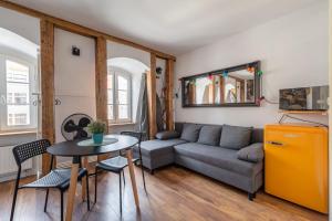 a living room with a couch and a table at RentPlanet - Studio Rynek Ratusz in Wrocław