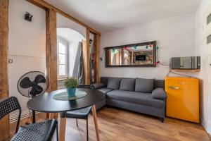a living room with a couch and a table at RentPlanet - Studio Rynek Ratusz in Wrocław