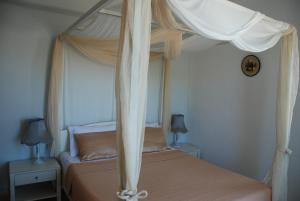 Postel nebo postele na pokoji v ubytování Villa Kampos Naousa-Marpisa