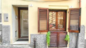 a building with an open window with a chair in it at Il Viandante in Cagliari
